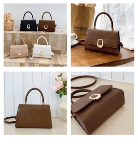 Detailed views of crocodile pattern crossbody bags with golden oval clasps and top handles