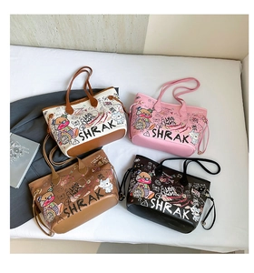 Flat lay of colorful graffiti tote bags showing artistic patterns and leather texture