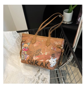 Close-up of brown graffiti tote bag featuring cartoon bears and urban art style design