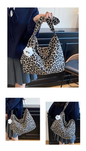 Detail view of large leopard print canvas hobo bag with cute white plush monster charm