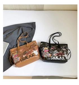 Detail view of stylish graffiti tote bags in brown and black with unique street art patterns