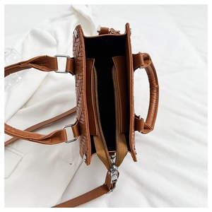 Top view showing the spacious interior and zipper compartment of a brown woven tote bag