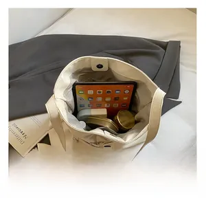 Interior view of beige leather tote bag showing large capacity for tablet and cosmetics