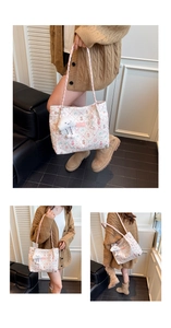 Detail of cream quilted tote bag with pink floral bear print and plush cloud charm