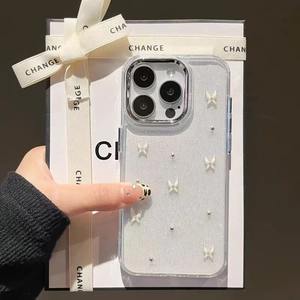 Glitter iPhone case with white bow and pearl details shown in luxury gift packaging
