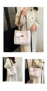 Detail of floral tote bag with pleated texture, leather straps and plush cloud charm