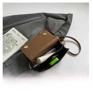 Internal view of brown crossbody bag showing storage capacity for phone and accessories