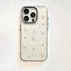 Detailed view of clear iPhone case with silver glitter, metal bow and rivet accents