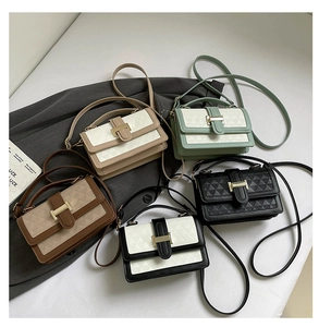 Close-up of small geometric quilted handbags with metal H-buckles in five colors