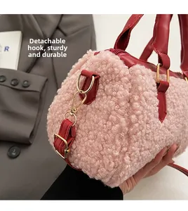 Detail of pink fleece cylinder bag with red leather trim and gold removable hardware