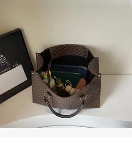 Detail view of spacious interior of monogram tote bag showing daily essentials