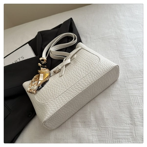 Detail of white crocodile texture faux leather tote bag with decorative yellow silk scarf