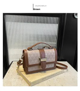 Detail view of the brown rhombic pattern flap bag with gold hardware and top handle