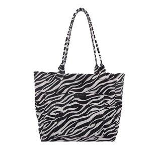 Large zebra print canvas tote bag with front pocket and dual shoulder straps for daily use