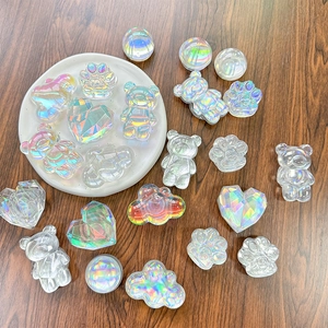 Iridescent laser crystal bear and cat paw phone grip stands on wooden background