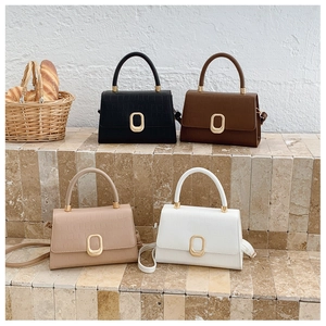 Collection of croc-effect leather handbags in four colors with gold oval metal clasps