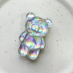 Detailed macro of a 3D holographic bear phone socket with vibrant rainbow light effects
