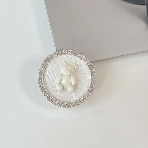 Detailed view of bear cell phone grip with sparkling rhinestones and white resin bear