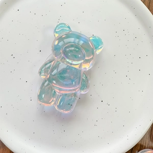 Detailed view of an aurora holographic bear phone grip with iridescent reflections