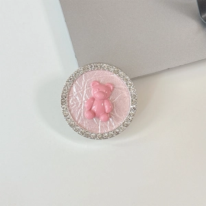 Macro view of pink bear phone grip with sparkling rhinestones and leather texture