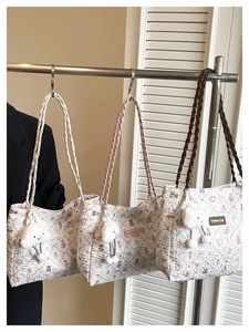 Detail showing three quilted tote bags with bear prints and cloud plush charms