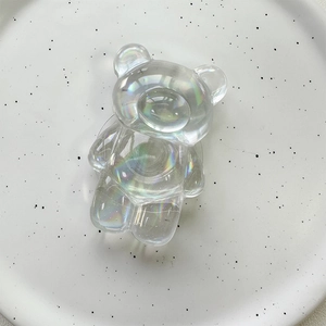 Detailed macro view of laser holographic bear phone stand with iridescent resin coating