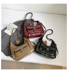 Three versatile shiny PU leather hobo bags in dark red, khaki, and black with bear charms