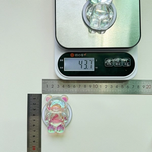 Holographic bear phone grip size and weight measurement on white surface