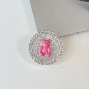 Close-up of pink bear phone socket grip with sparkling crystal rhinestones and silver base