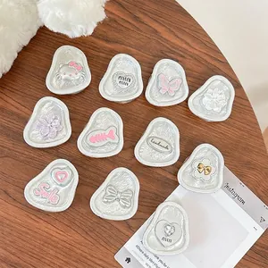 Floral butterfly resin phone grip set with ice crackle texture on wooden table