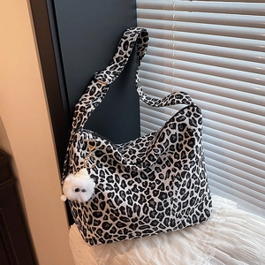 Vintage black and white leopard print canvas hobo bag with cute plush charm for women