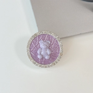Detail of round phone socket holder with 3D teddy bear and crystal rhinestone border