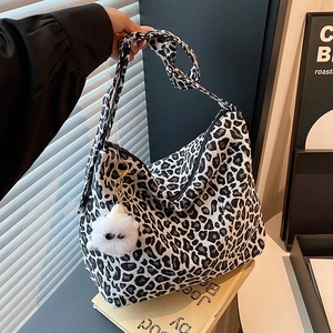 Retro black and white leopard print canvas tote bag with plush charm on shoulder strap
