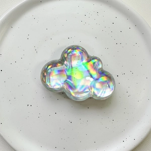 Close-up of holographic cloud phone socket with iridescent finish on a ceramic plate