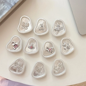 Silver rhinestone phone grip set with heart, cherry, and Saturn cosmic charms