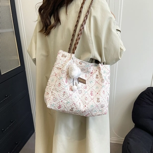 Fashionable floral tote bag with wrinkled texture and brown braided shoulder straps