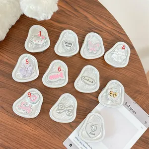 Close-up of decorative floral and butterfly phone sockets with silver textured base