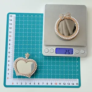 Macro view of pearl bow and crown mirror phone sockets showing size on scale