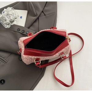 Top view of pink plush pillow bag with red leather straps and interior detail
