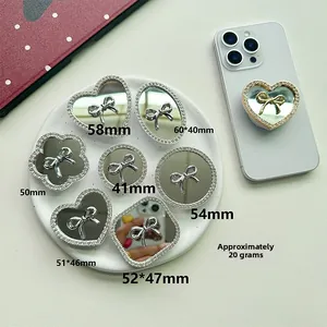 Detailed view of various glittery rhinestone phone socket mirrors with bow designs