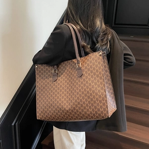 Vintage brown monogram tote bag with repeating M pattern for casual daily commuting