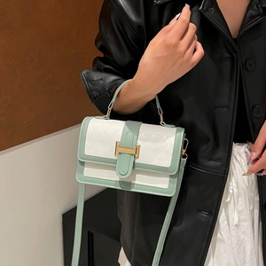 Quilted two-tone flap bag in cream and green with gold metal buckle and top handle