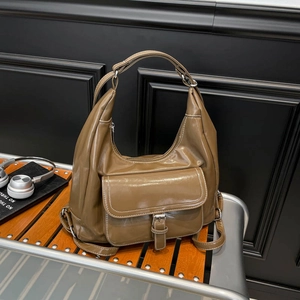 Vintage brown oil-wax leather tote bag with silver hardware and front buckle pocket