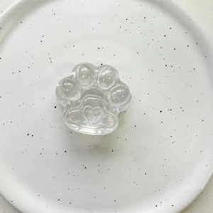 Detailed top view of a laser iridescent cat paw phone socket on a white ceramic plate