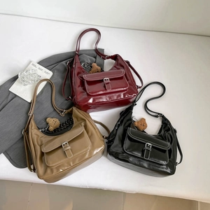 Three retro faux leather hobo bags in burgundy, khaki, and black with cute bear charms