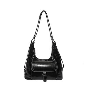 Retro black high-gloss shoulder bag with contrast stitching and metal buckle detail
