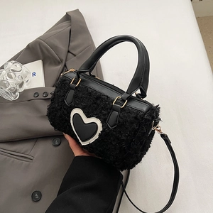 Chic black plush heart-shaped pillow bag with faux leather straps and golden hardware