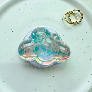 Close-up of holographic cloud phone socket grip with iridescent acrylic finish