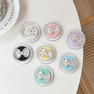 Set of seven colorful polka dot bow magnetic phone stands with a sleek pearl finish