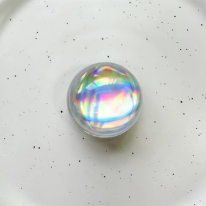 Detailed view of an iridescent laser crystal ball phone holder with vibrant rainbow shimmer